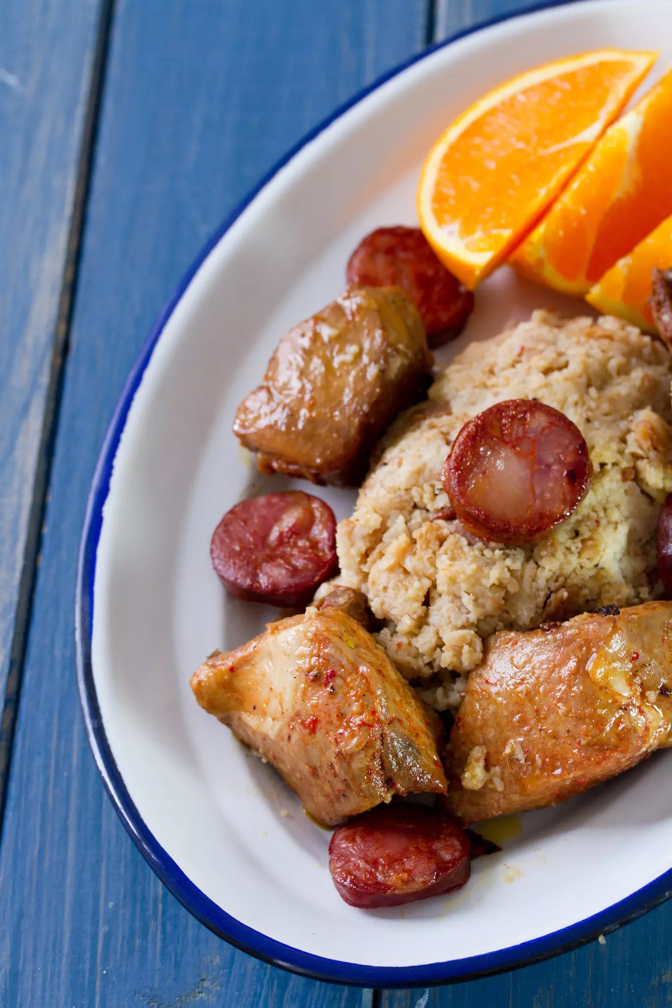 Meat with bread, smoked sausages and orange.