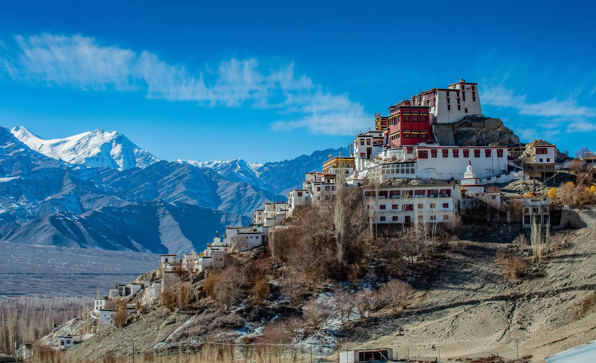 Thiksey Monastery in front of snowy mountains in Ladakh, India.