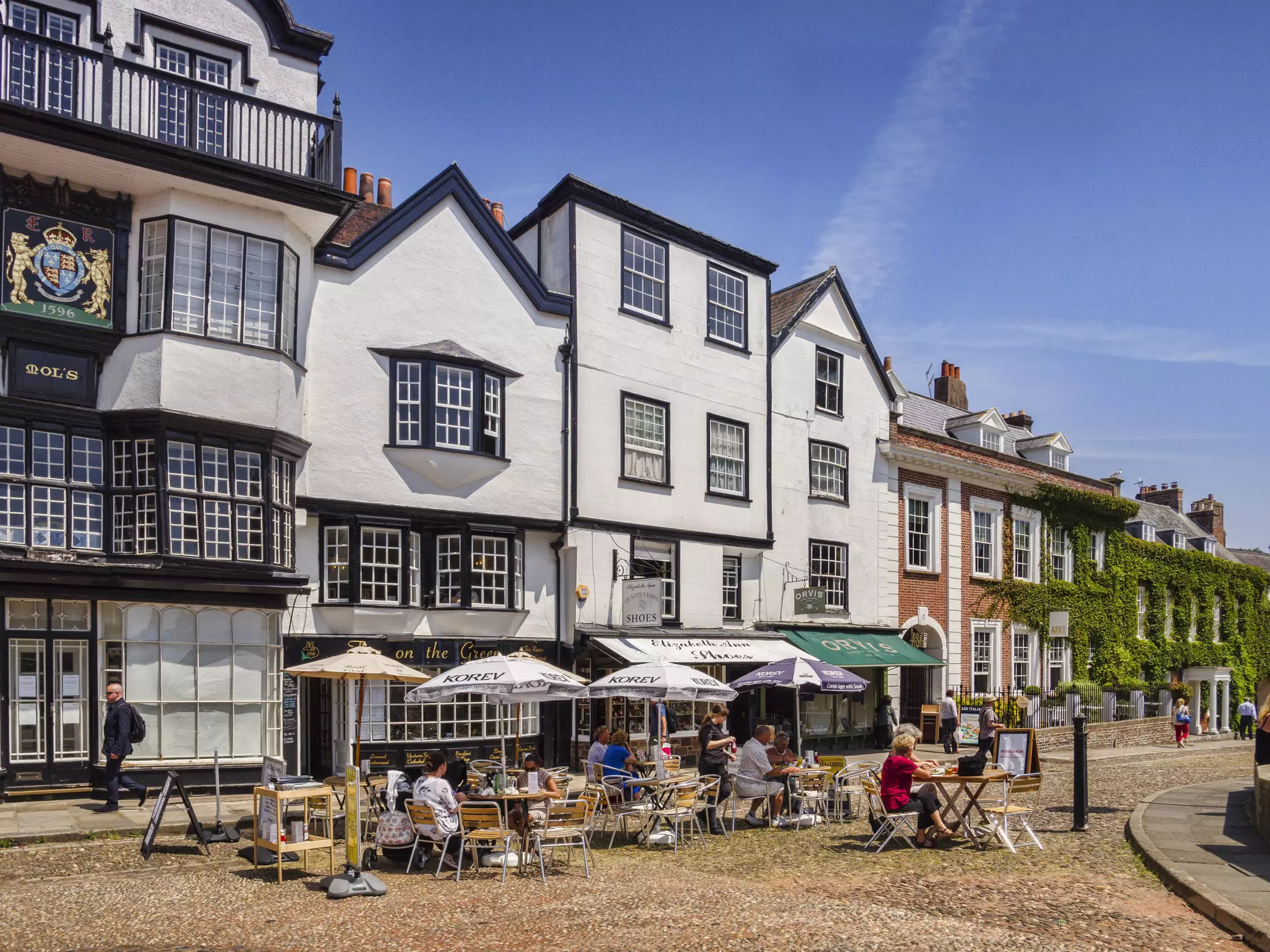 People eating alfresco on Cathedral Green in Exeter, Devon, England.