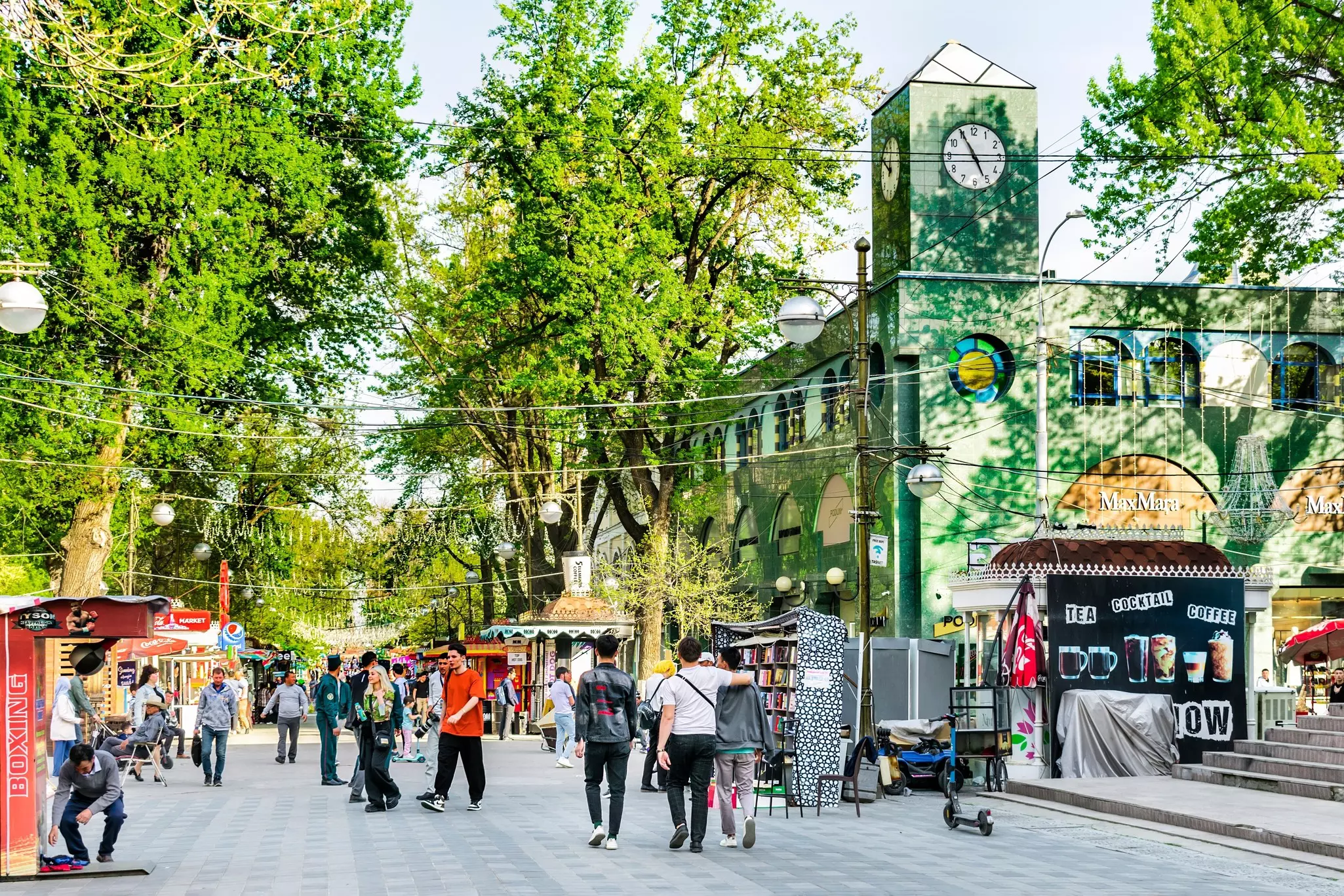 Pedestrians stroll on a shopping street during springtime in Tashkent.
