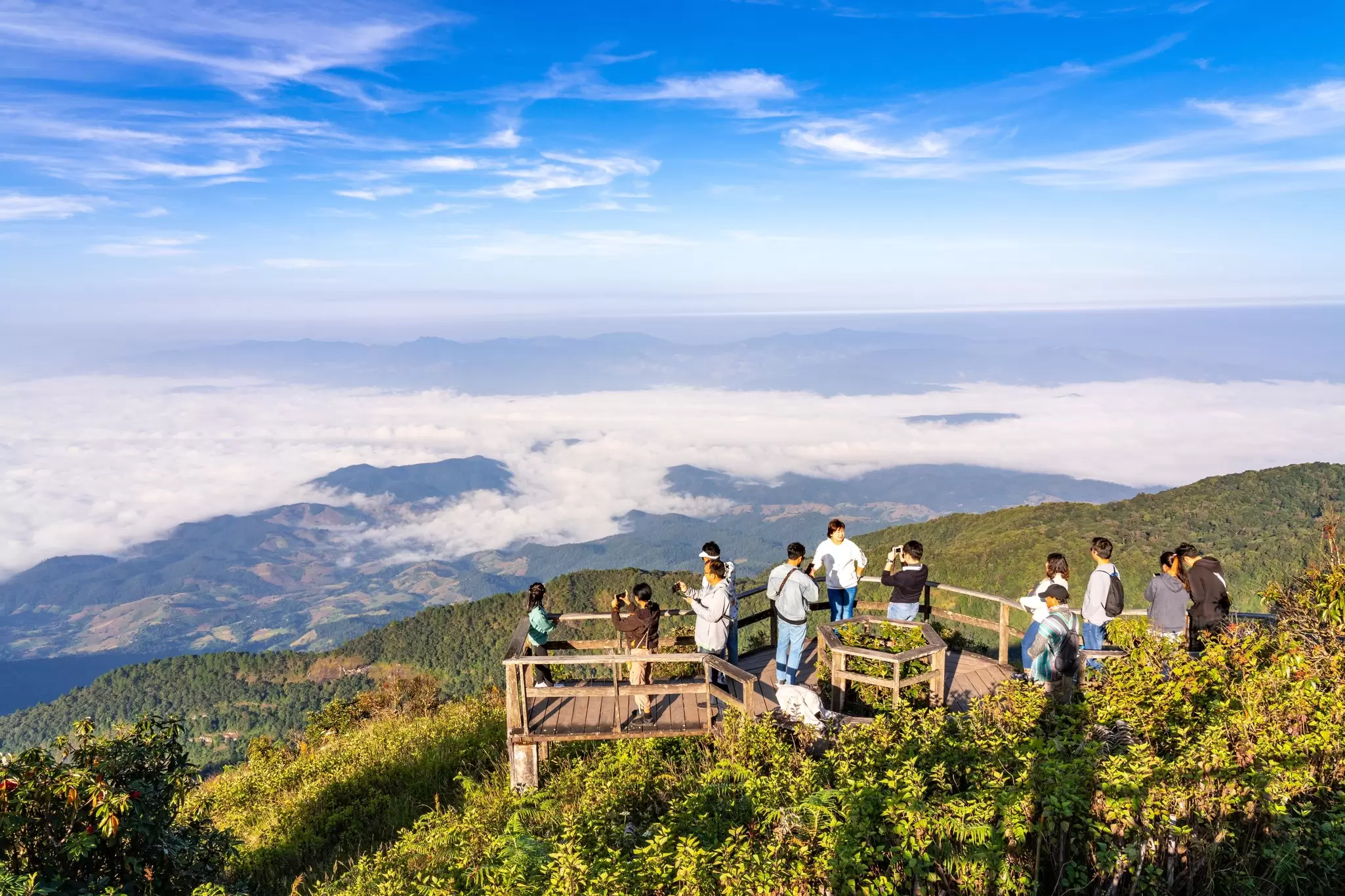 Visitors taking their morning sunrise pictures at the viewpoint area of the beautiful Kew Mae Pan Nature Trail on Doi Inthanon mountain in Chiang Mai, Thailand.
