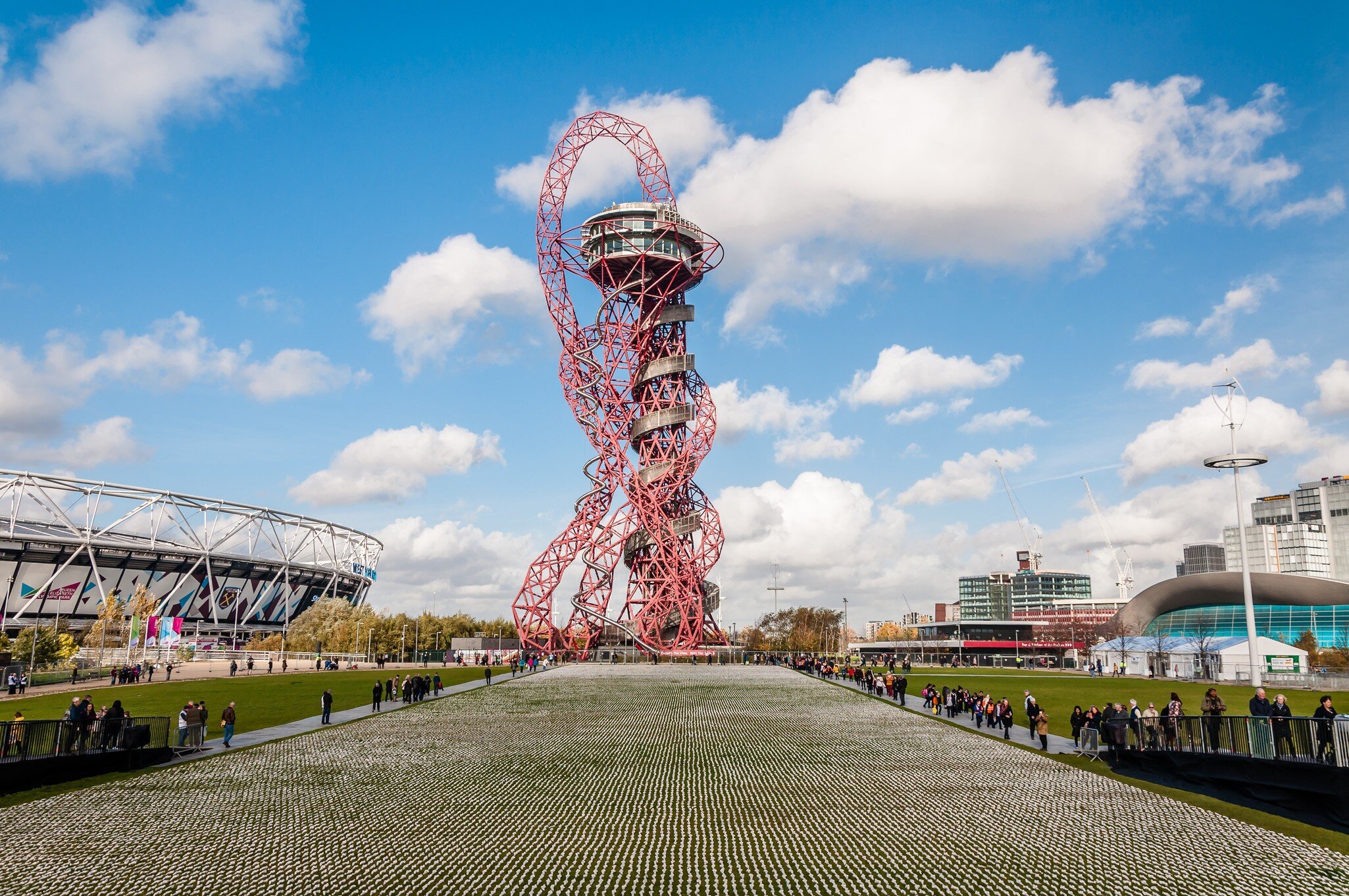 The Shrouds of the Somme artwork, which features 72,396 small human figurines, each separately wrapped in a calico shroud. The ArcelorMittal Orbit tower is in the background.
1226333209
arcelormittal orbit, architecture, armed forces, attraction, battlefield, blue, building, capital, centenary, city, cityscape, commemorate, elizabeth, england, entertainment, first, forces, france, graveside, killed, kingdom, landmark, london, olympic stadium, park, queen elizabeth, remembrance, rob heard, service men, shrouds, sky, somme, stratford london, street, tourism, tourist, town, travel, urban, view, war, wheel, world