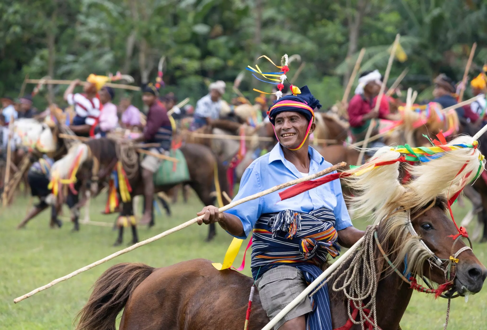 A man wearing a traditional costume and holding a spear for a festival is pictured on horseback.