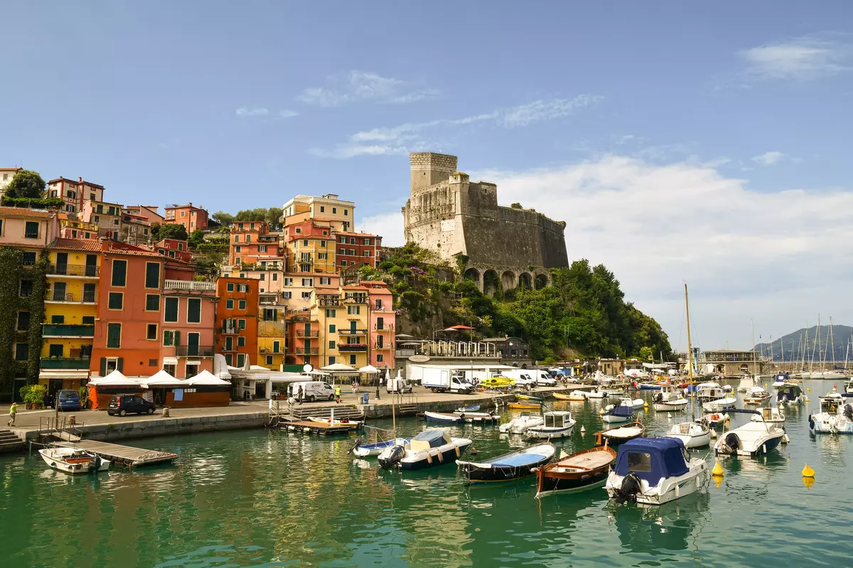 Lerici, La Spezia / Italy - June 25 2020: View of the harbor of the old fishing village with the typical colored houses and the medieval castle in summer