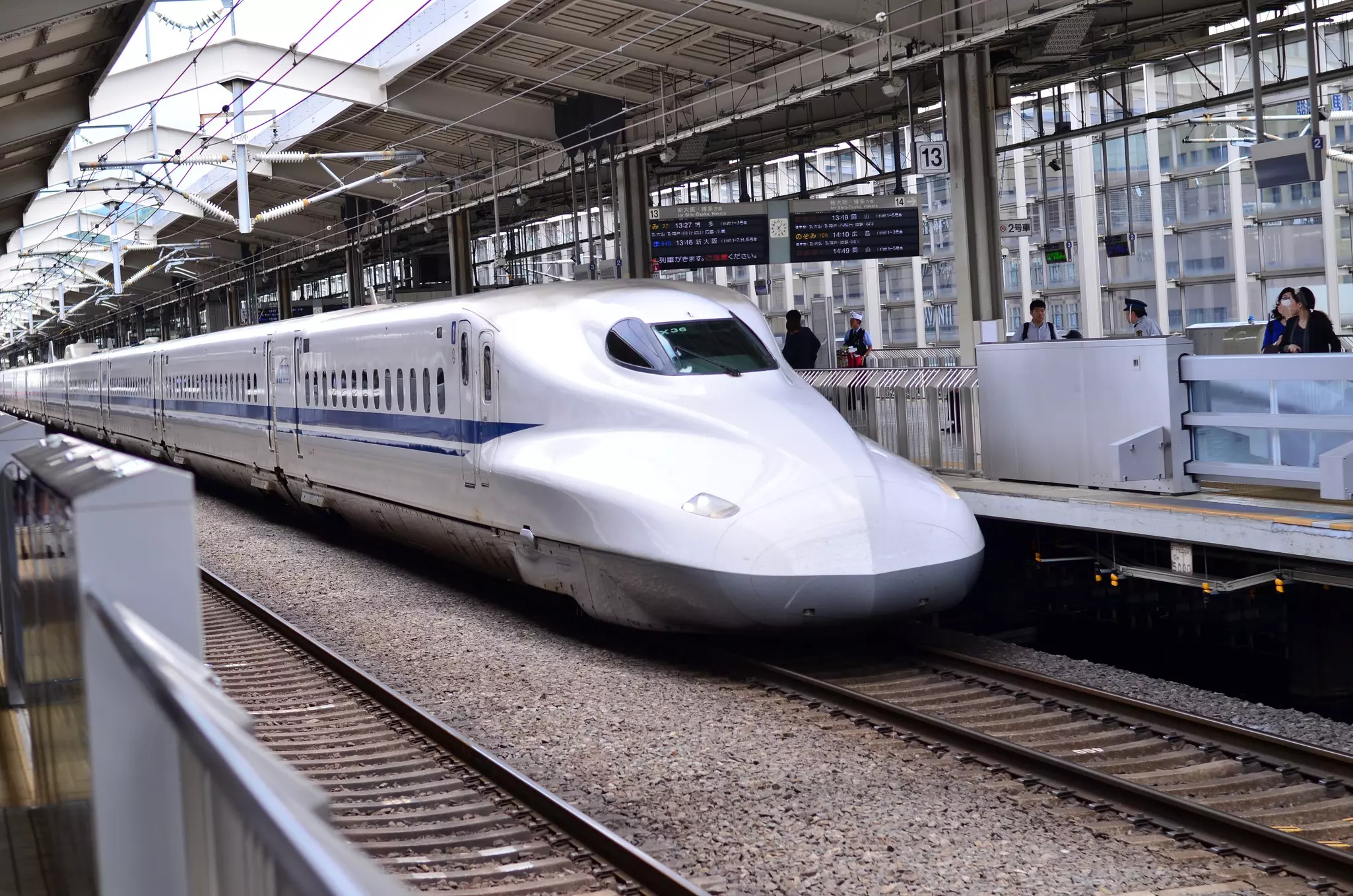 A sleek white train at a station stop
