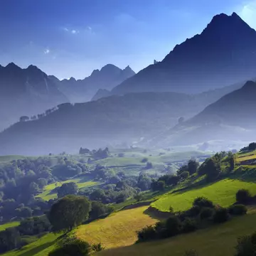 Overview of stepped farmland and Pinnacle of Pic du Jer.