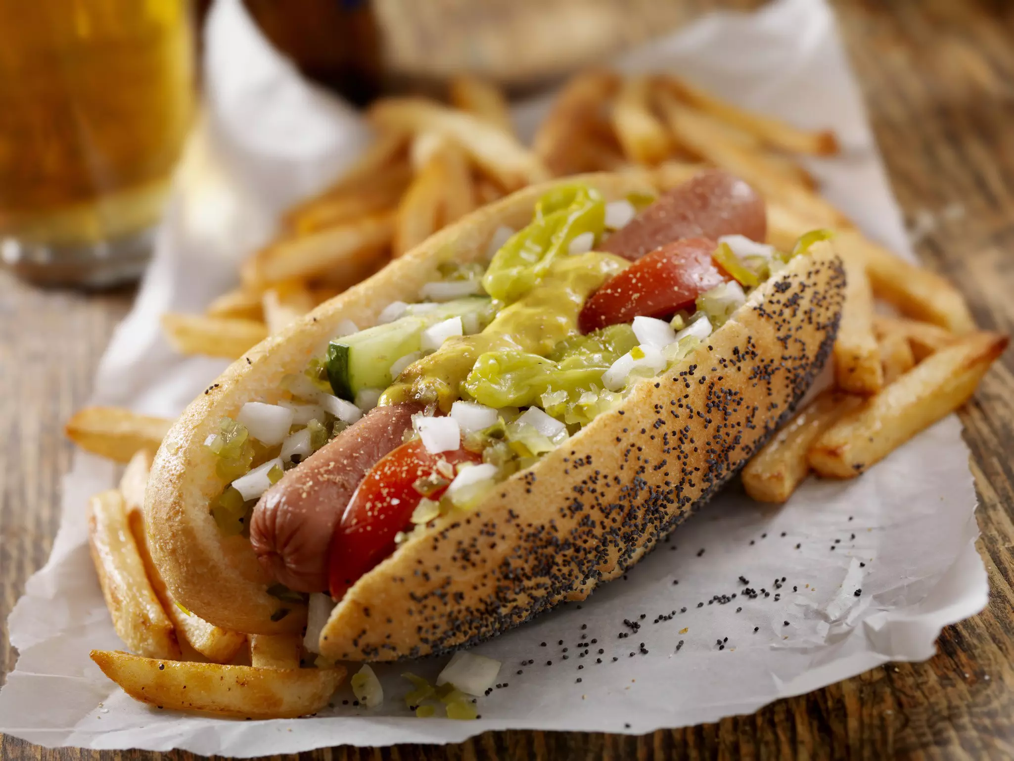 A classic Chicago dog has fresh tomatoes, diced onions, green relish, peppers, pickle, yellow mustard and a dash of celery salt. © Lauri Patterson/Getty Images