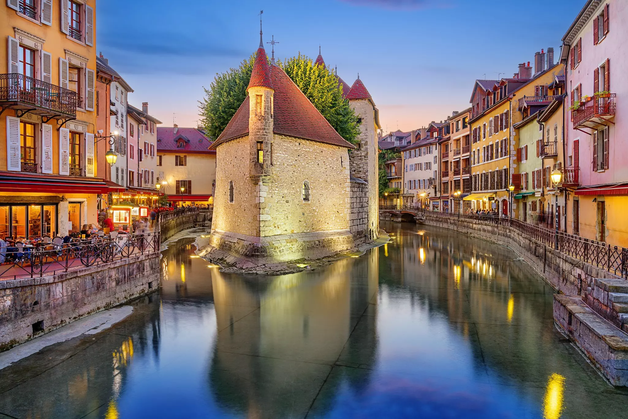 The Palais de l’Isle in the River Thiou at twilight.