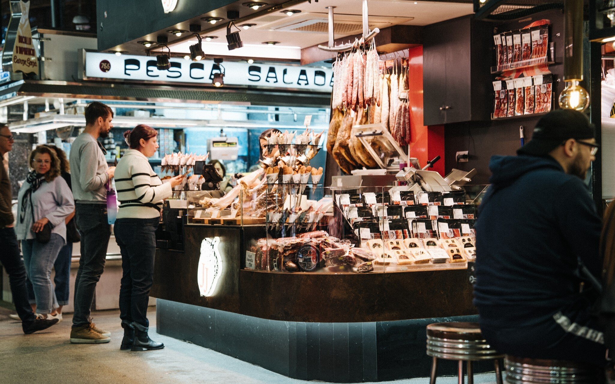 People visiting the local market hall, Mercat de Sant Antoni, in Barcelona, Spain.