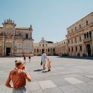 People walk through the Piazza del Duomo in Lecce, Puglia.