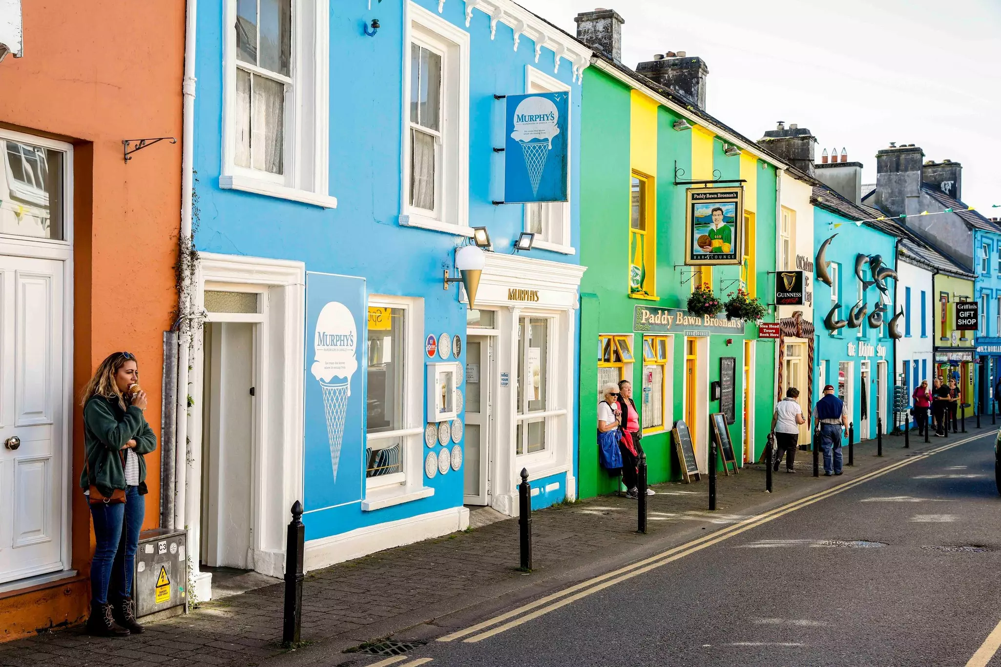 Colorful shops and patrons in Dingle, Ireland