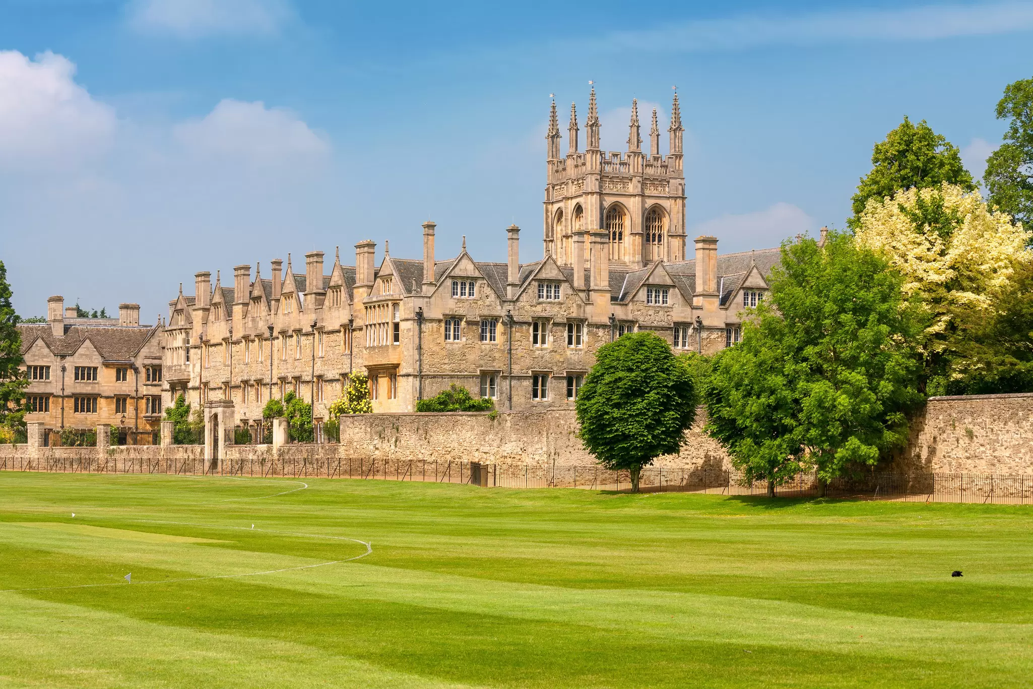 View across a lawn of Merton College, part of Oxford University in Oxford, UK, on a sunny day.