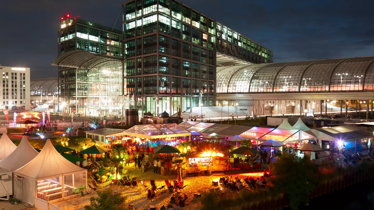 An outside bar in Berlin is busy at nighttime.