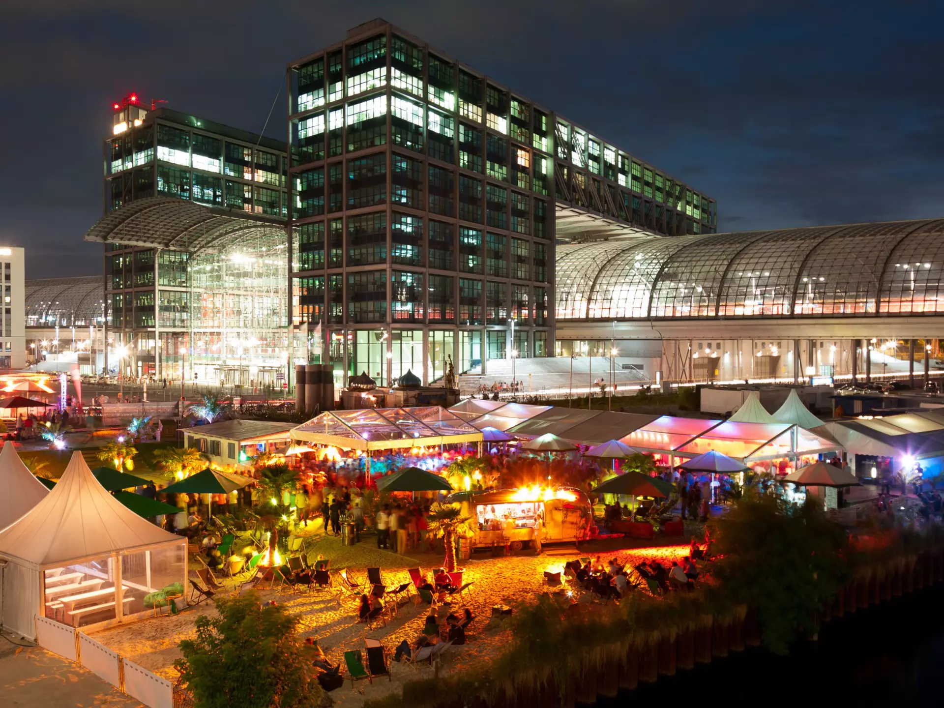 An outside bar in Berlin is busy at nighttime.