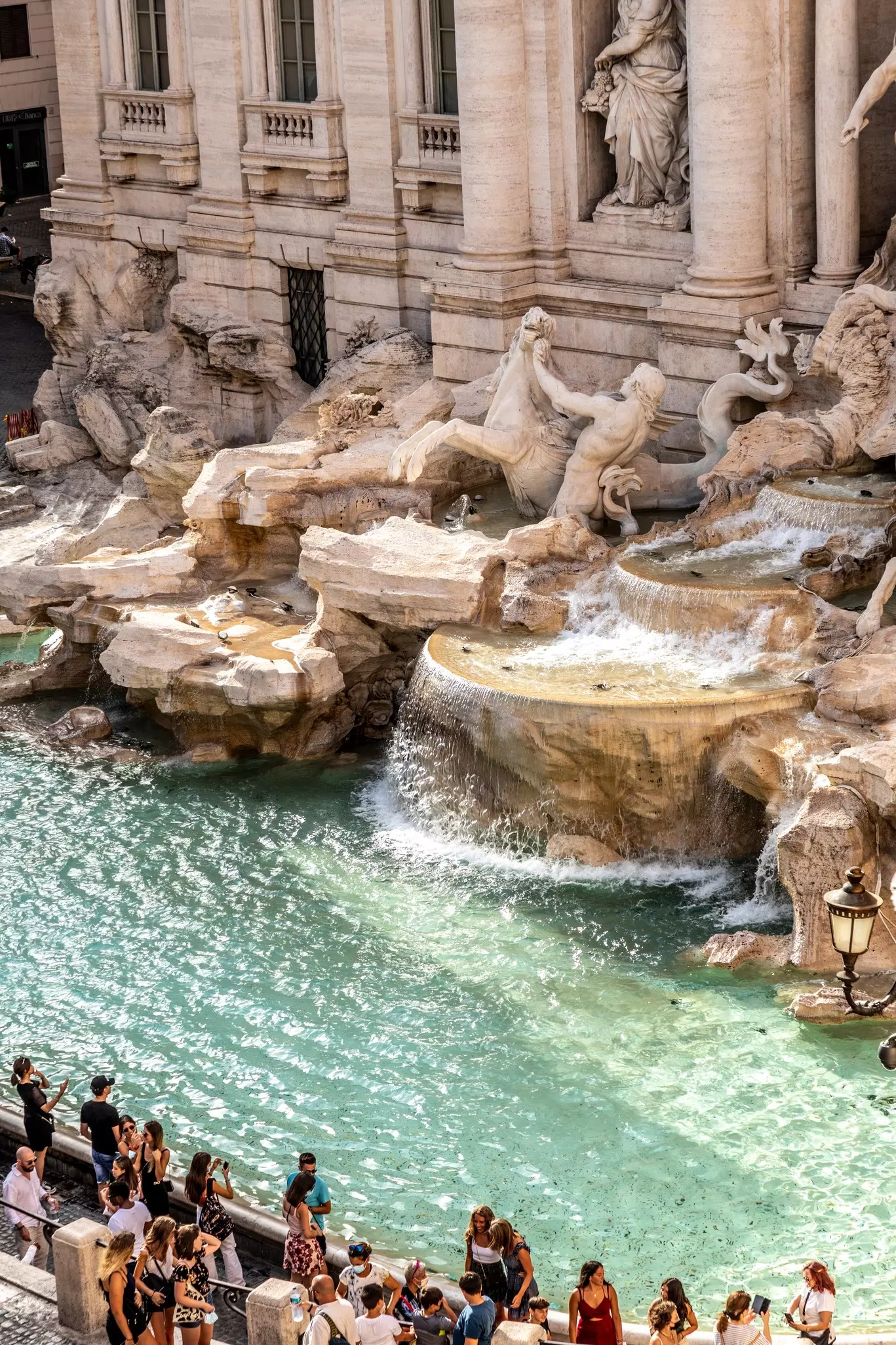 People visiting the Trevi fountain in Rome