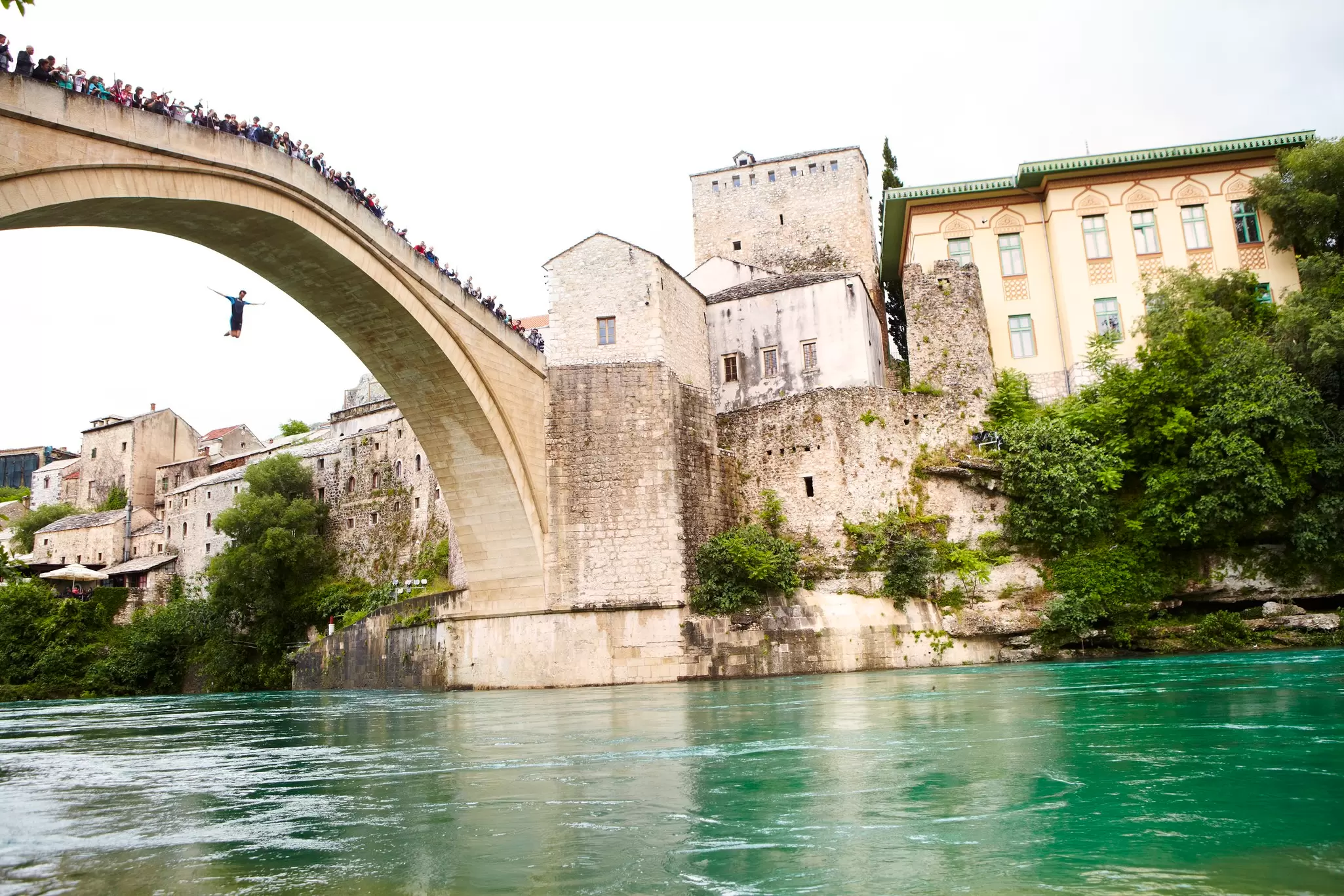 Local man jumping from Mostar's Stari Most. Matt Munro / Lonely Planet
