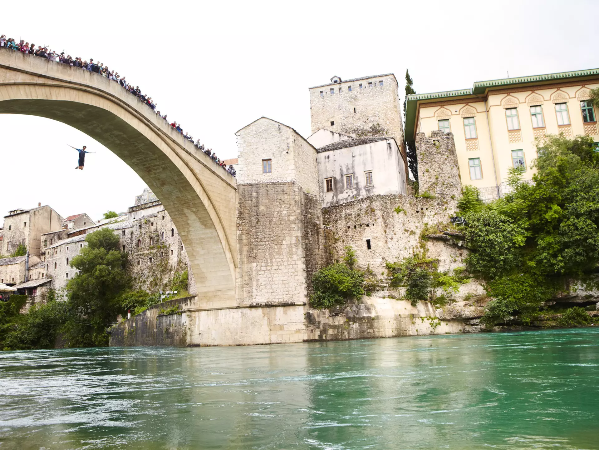 Local man jumping from Mostar's Stari Most. Matt Munro / Lonely Planet