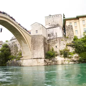 Local man jumping from Mostar's Stari Most. Matt Munro / Lonely Planet
