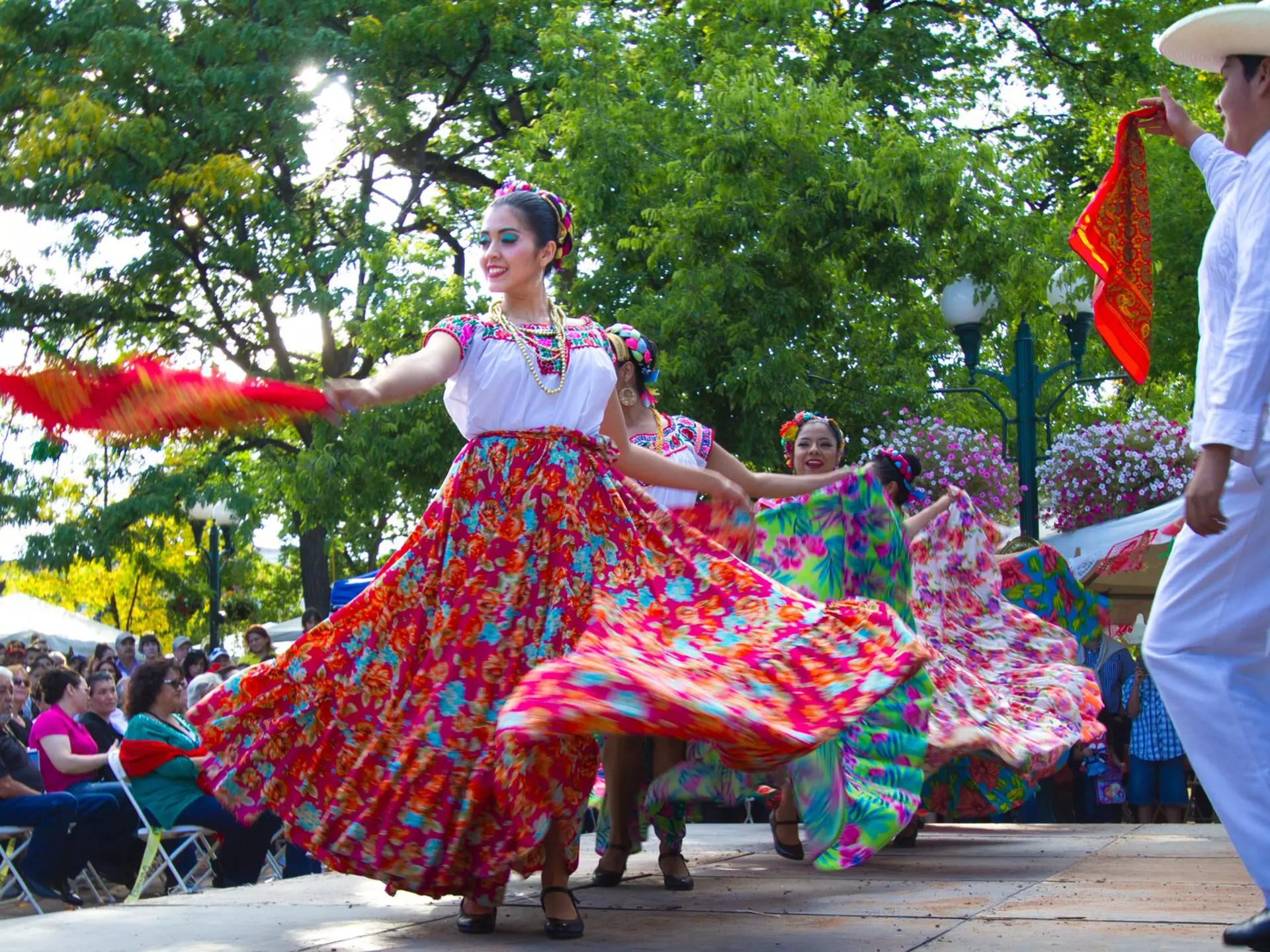 Santa Fe, NM, USA - September 17, 2016: A dance troupe performs a Mexican folk dance on the historic Santa Fe, NM Plaza during a Mexican Independence Day celebration. New Mexico was part of the Mexican Republic for 25 years and has many citizens of Mexican heritage.
637182922
Editorial, Vibrant Color, Performing Arts Event, Dancer, Holiday, Celebration, Skirt, Bandana, Mexican Culture, Folk Dancing, Dancing, Mexican Ethnicity, Period Costume, Action, Performance, Happiness, Motion, Multi Colored, White, Red, Cultures, Travel Destinations, Outdoors, Horizontal, Cheerful, Audience, Performer, Santa Fe, New Mexico, Southwest USA, Mexico, Tree, Town Square, Costume, Stage Costume, Dance Troupe, Independence Day