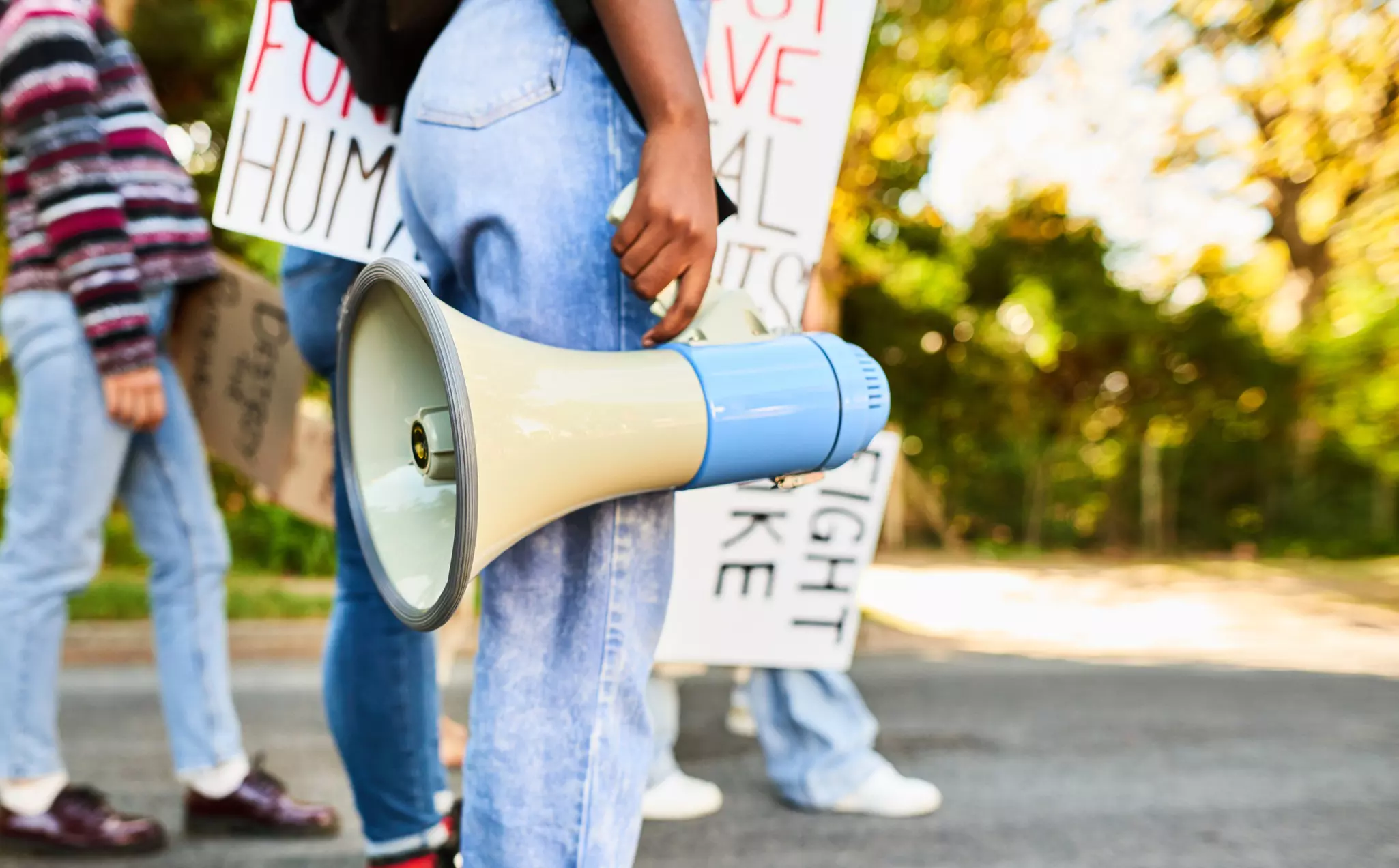 Woman standing with a megaphone during a women's rights day march