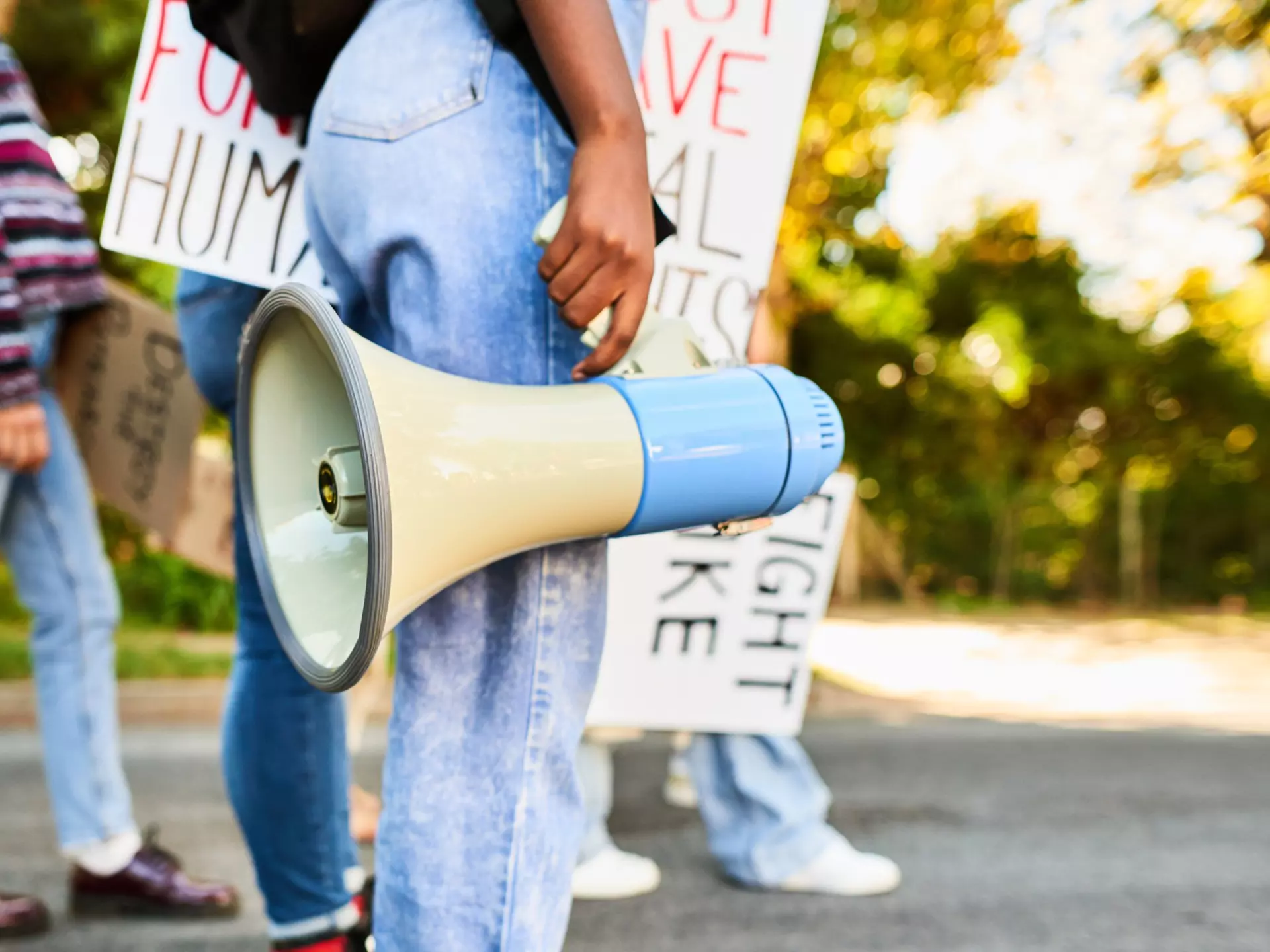 Woman standing with a megaphone during a women's rights day march