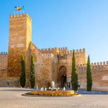 View of the Alcázar de la Puerta de Sevilla, a Moorish castle fortress in the Andalusian town of Carmona, Spain.