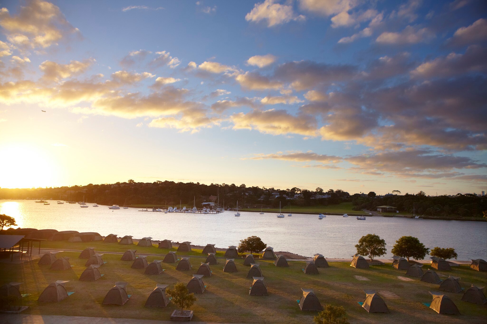 Campsite on Cockatoo Island overlooking harbour at sunset. Sydney, Australia.