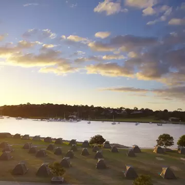 Campsite on Cockatoo Island overlooking harbour at sunset. Sydney, Australia.