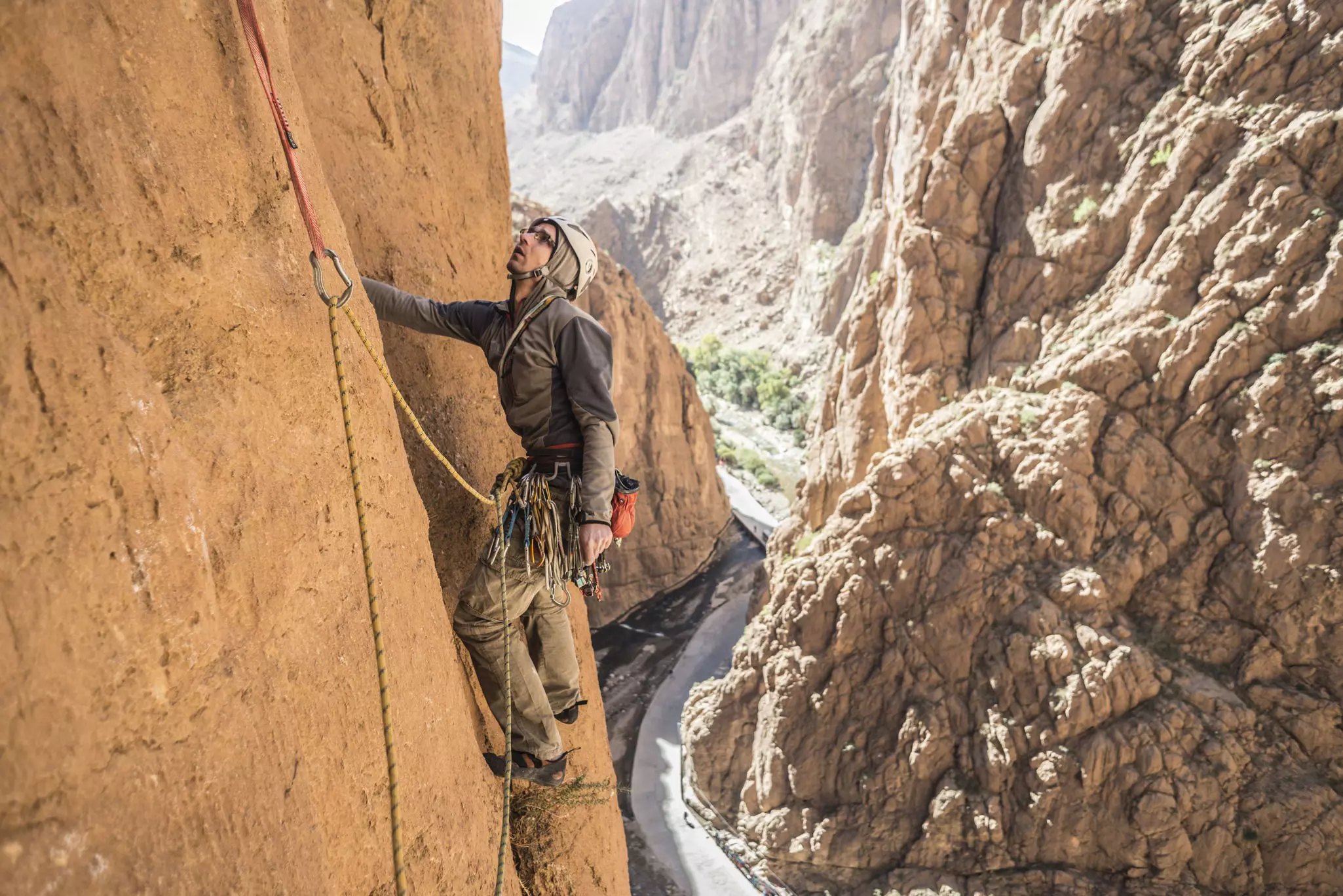 Man rock climbing in Todra Gorge in the Atlas Mountains, Morocco