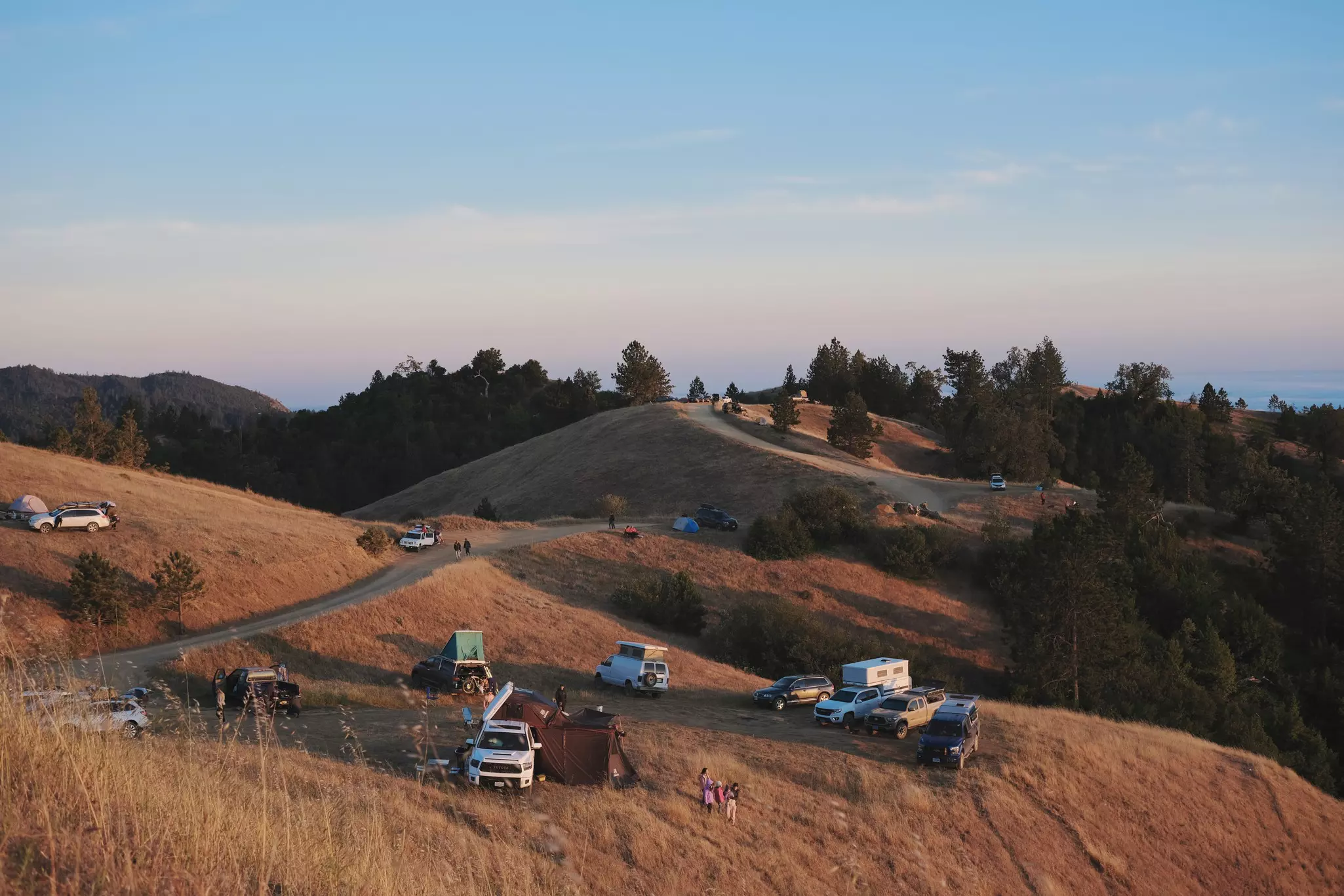 Cars with tents are scattered around a vast campground near Big Sur, California