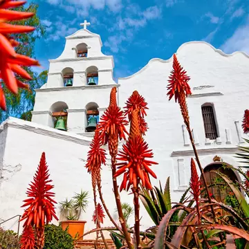 Mission Basilica San Diego de Alcala. - stock photo

California's first mission.  Aloe plants blooming in foreground.