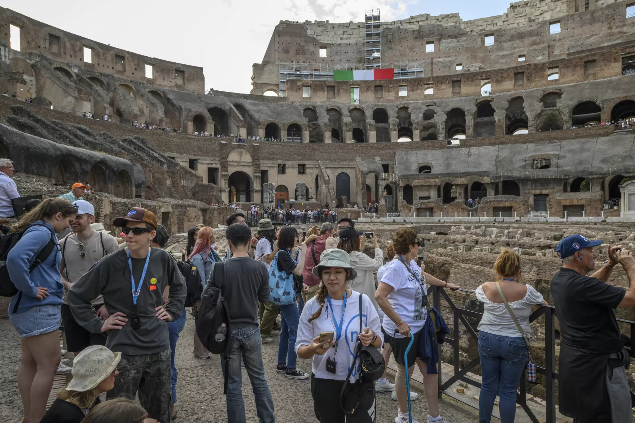 Tourists crowded on the floor of the Colosseum in Rome