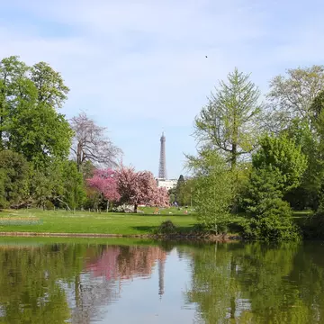 The Bois de Boulogne lake in Paris, with the Eiffel Tower standing tall on the horizon.