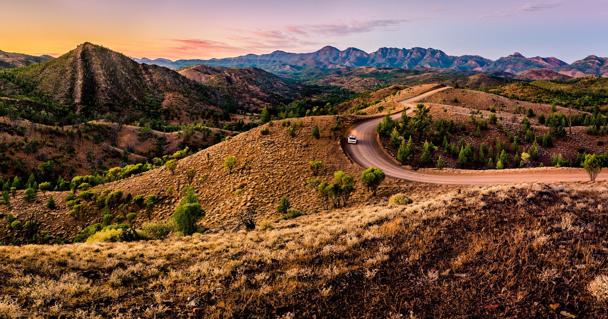 A car driving in the distance on a dirt road at Bunyeroo Valley in Flinders Ranges, South Australia. 