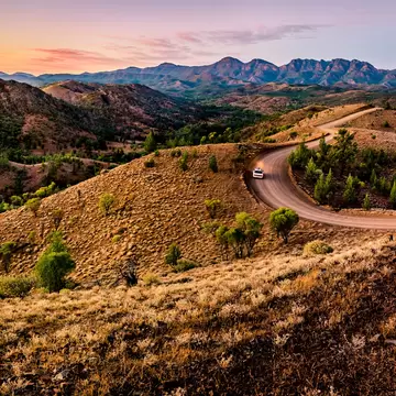 A car driving in the distance on a dirt road at Bunyeroo Valley in Flinders Ranges, South Australia. 