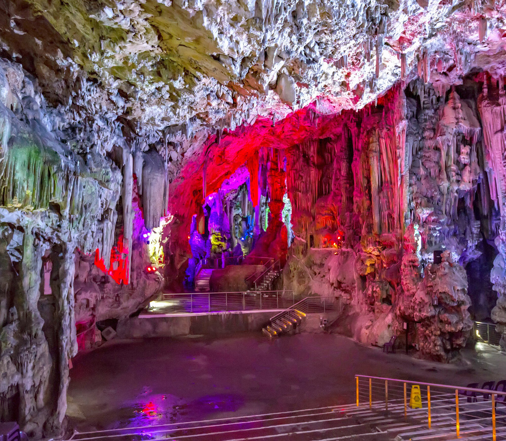 View of illuminated rock formations inside St Michael's Cave in Gibraltar.