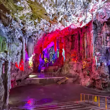 View of illuminated rock formations inside St Michael's Cave in Gibraltar.