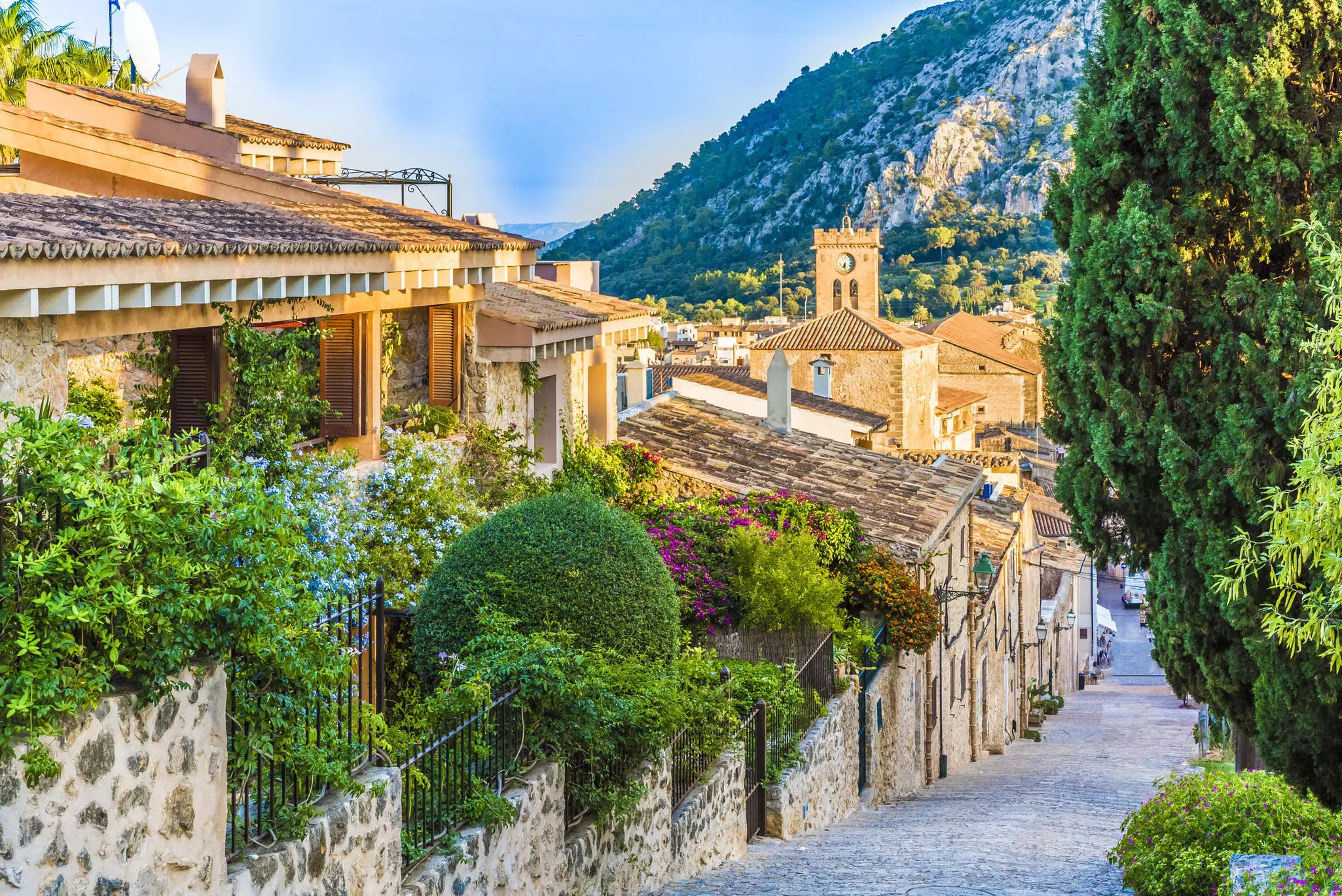 A steep street in an old village glowing in the spring sunshine.