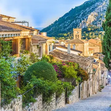 A steep street in an old village glowing in the spring sunshine.