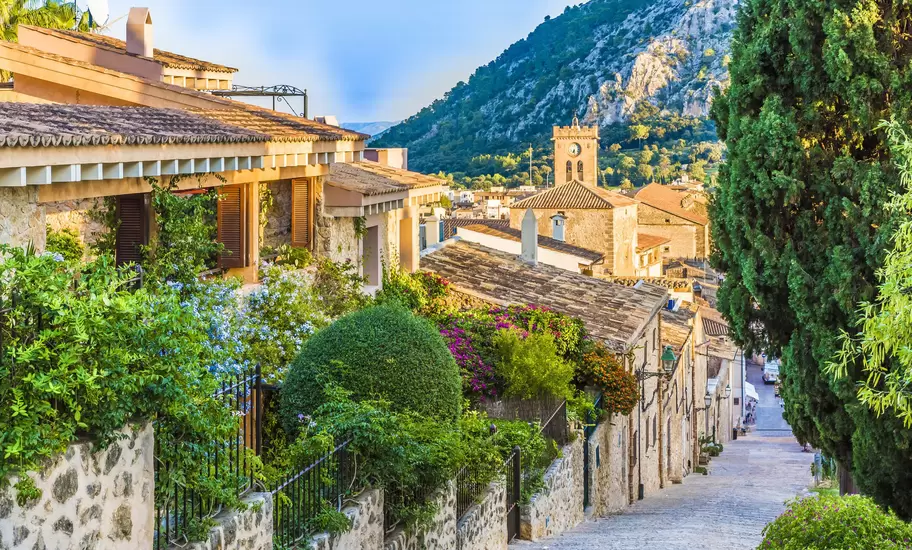 A steep street in an old village glowing in the spring sunshine.