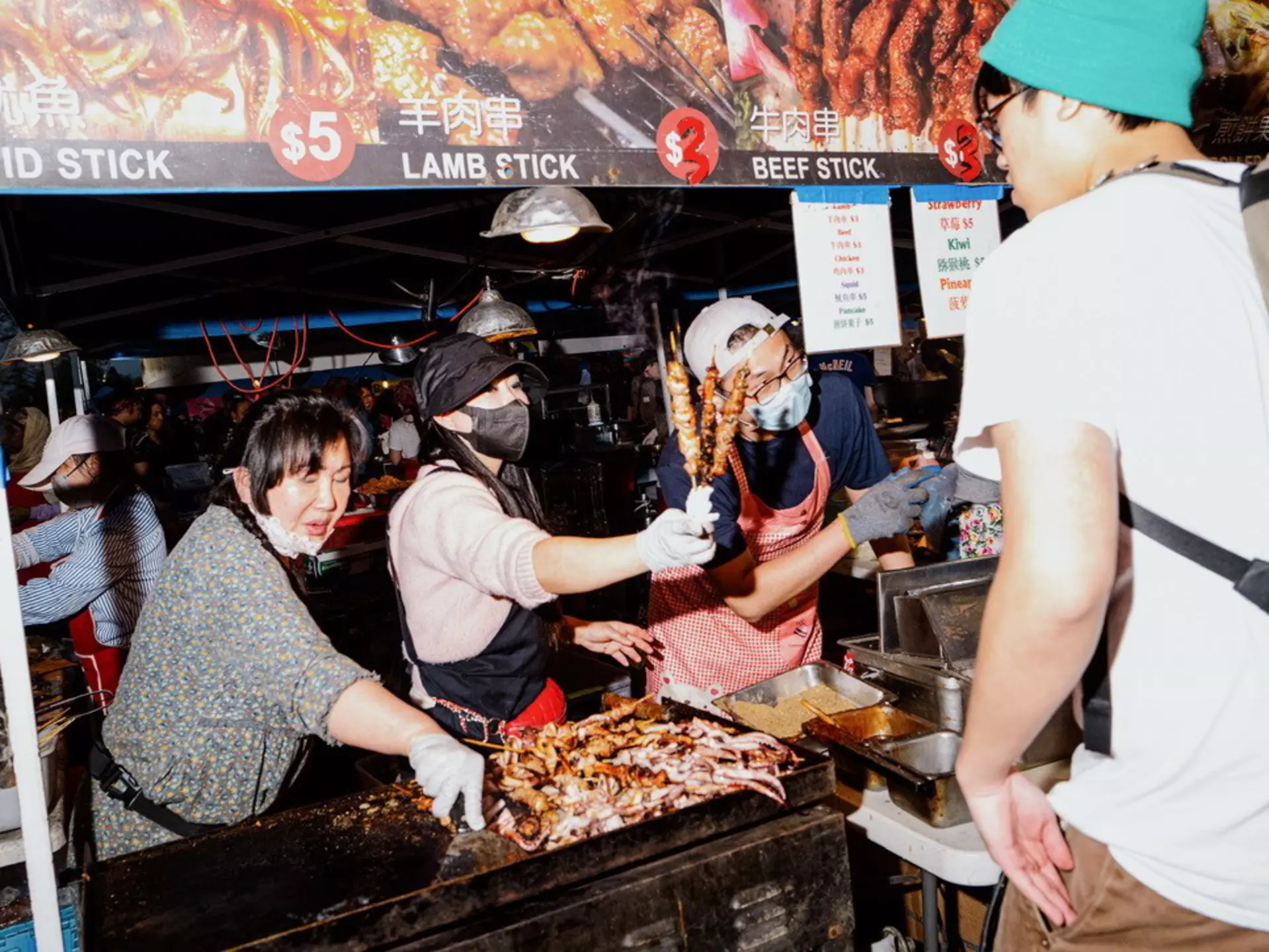 a vendor selling skewers at the market. 