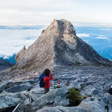 23 April, 2018: hikers pause to photograph the Mount Kinabalu peak (4095m).
1081670372
adventure, altitude, asia, asian, beautiful, blue, borneo, climb, climbing, cloud, clouds, heritage, high, hiking, hill, journey, kinabalu, kota, landscape, malaysia, mount, mountain, mountains, mt, natural, nature, outdoor, outdoors, park, peak, people, recreation, rock, sabah, scenery, scenic, sky, south, summit, sunrise, top, tourism, travel, trekking, unesco, view