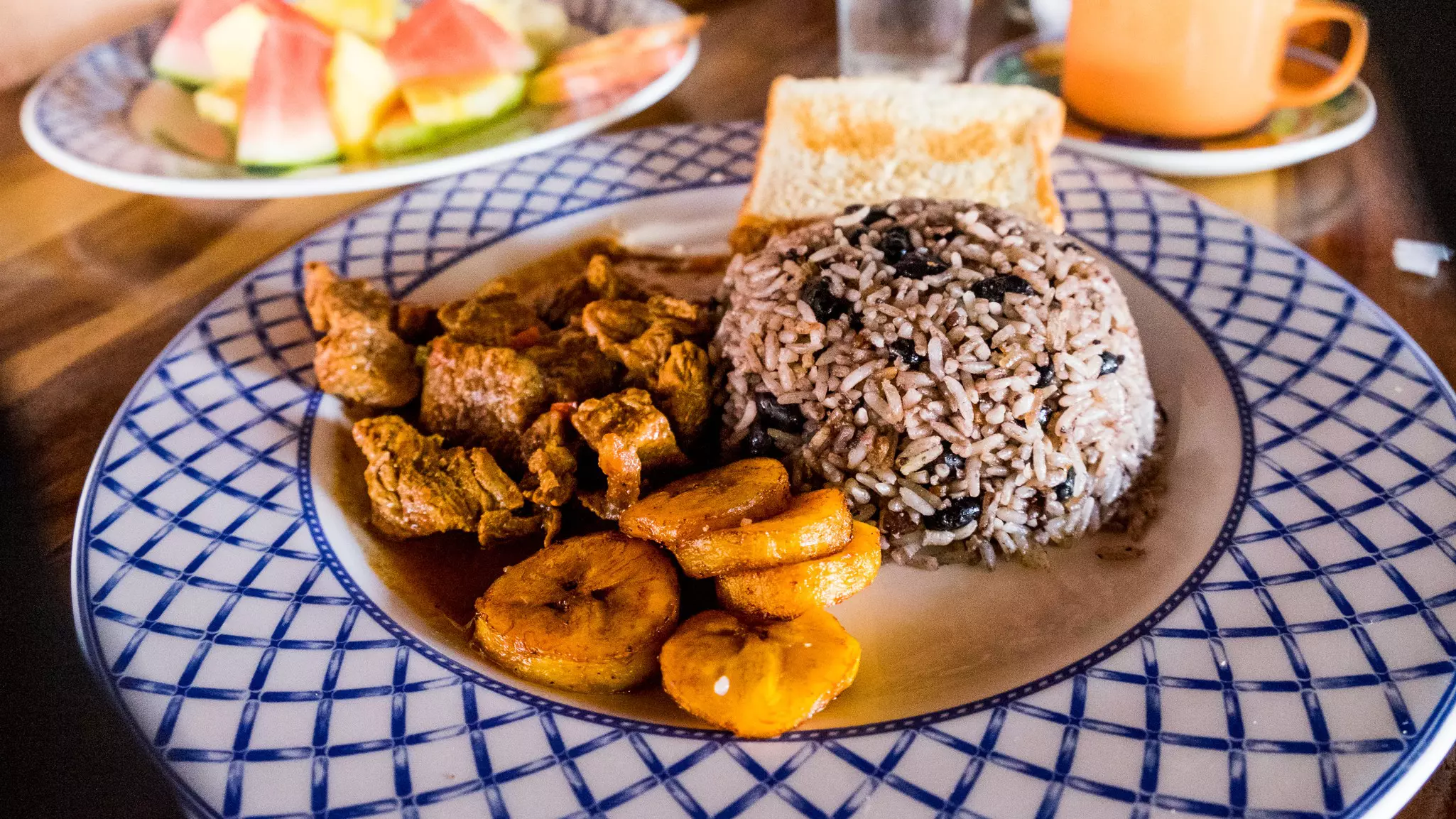 A plate of gallo pinto (rice and beans) with sides in Costa Rica.