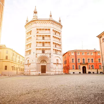 Parma cathedral with Baptistery leaning tower on the central square in Parma town in Italy. RossHelen / Getty Images