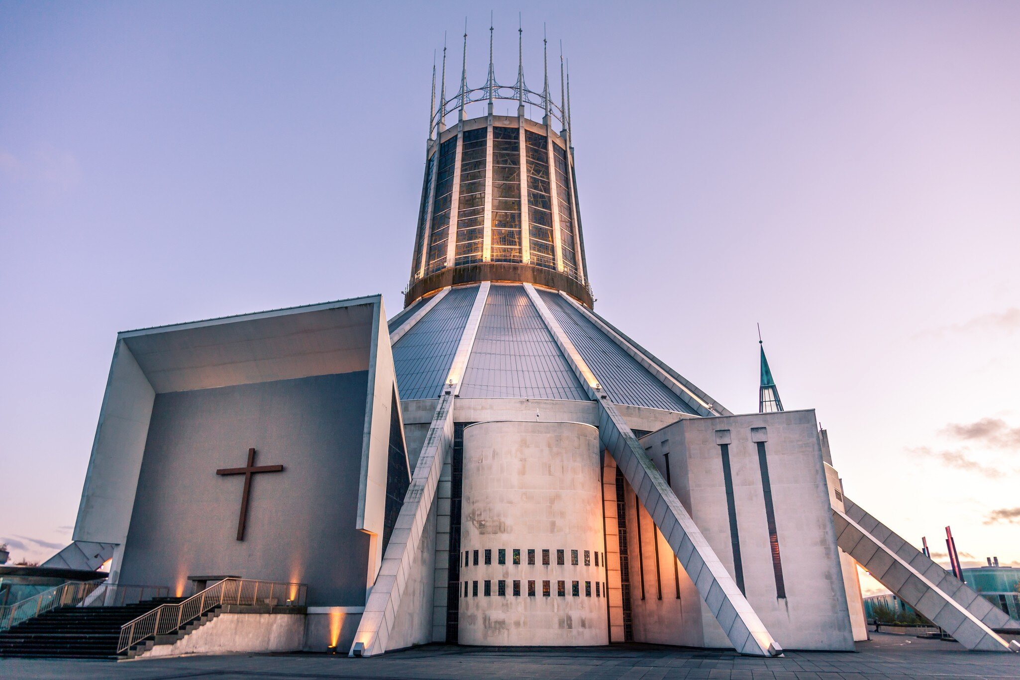 Front view of the Roman Catholic Liverpool Metropolitan Cathedral with stained glass panels at the base of the steps in the foreground, Liverpool, Merseyside, England.