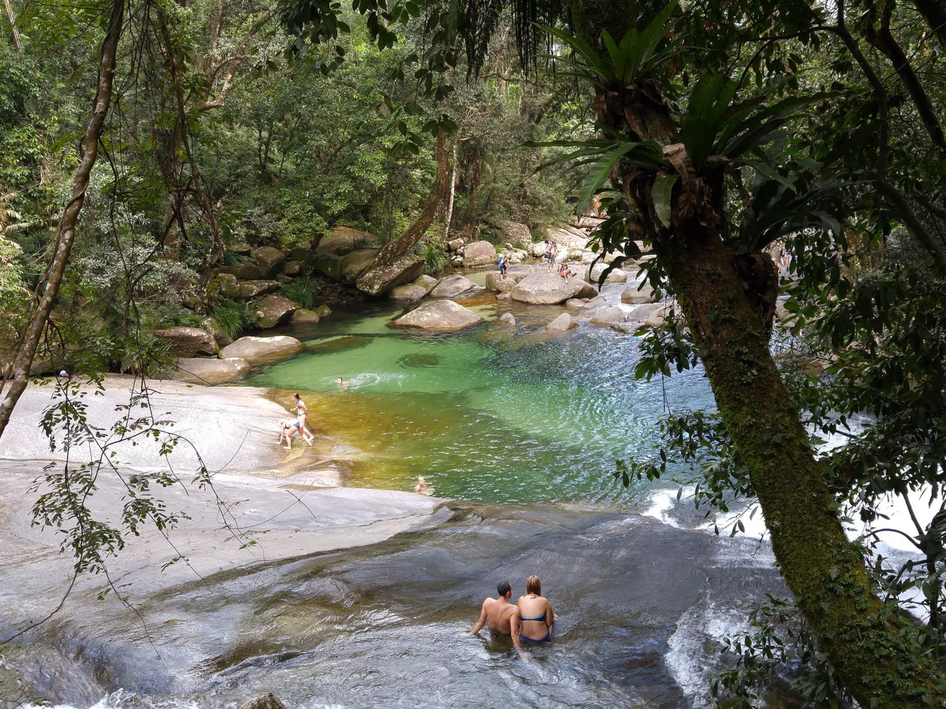People bathing at Josephine Falls, a tiered cascade waterfall on Josephine Creek located in the Far North region of Queensland