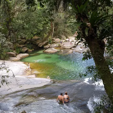 People bathing at Josephine Falls, a tiered cascade waterfall on Josephine Creek located in the Far North region of Queensland