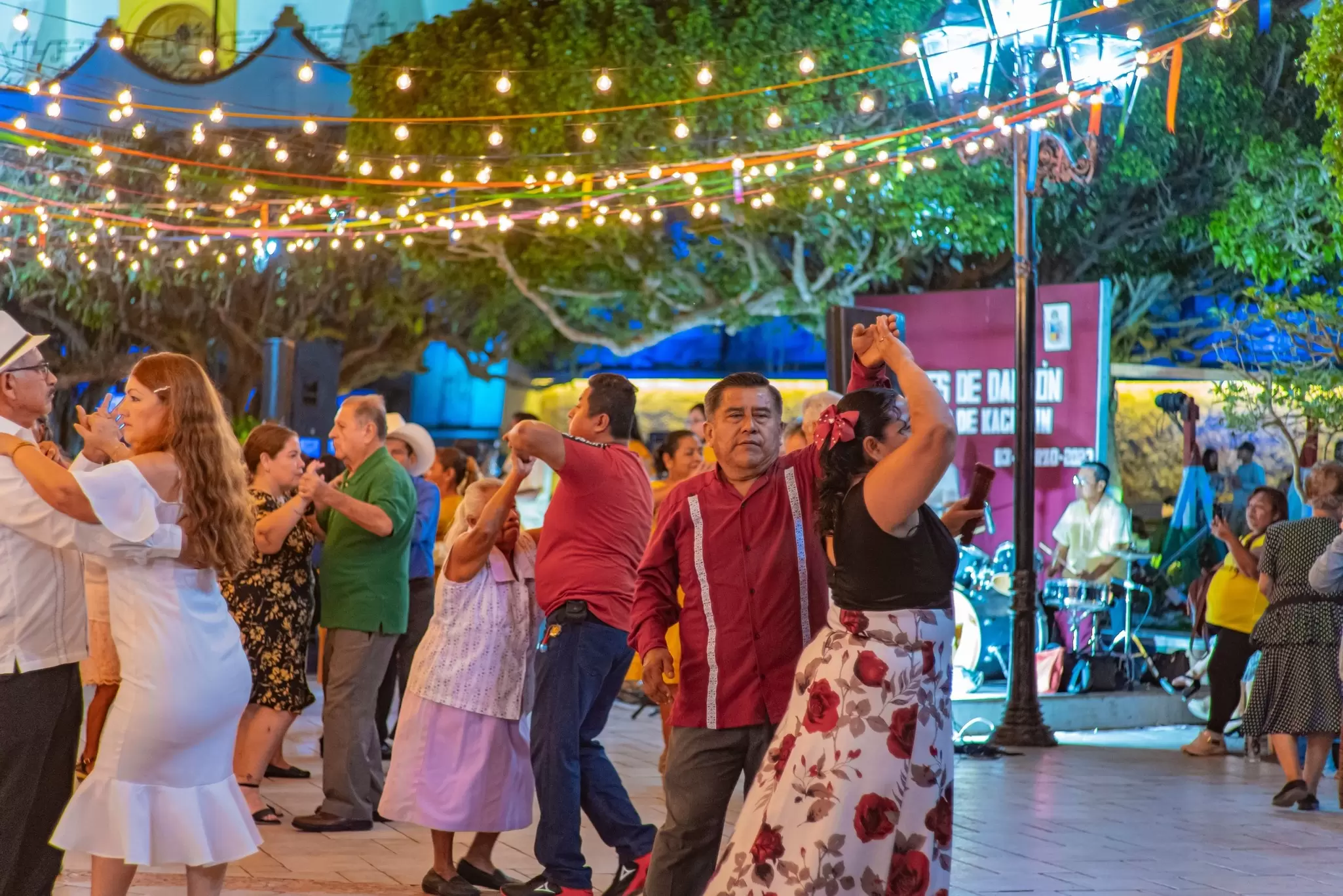 Couples dance under strings of lights set up in a public plaza in Veracruz City, Mexico