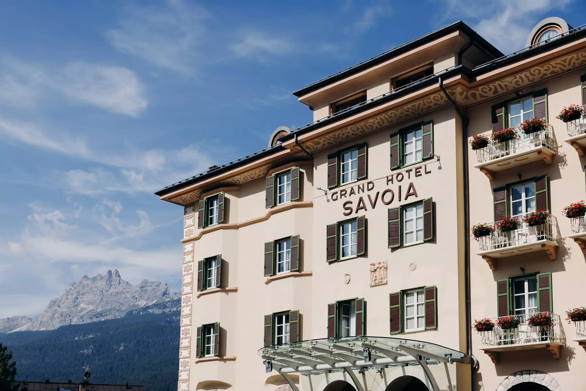 Exterior view of Grand Hotel Savoia Cortina d’Ampezzo, A Radisson Collection Hotel, the Tofane mountains are visible in the background
