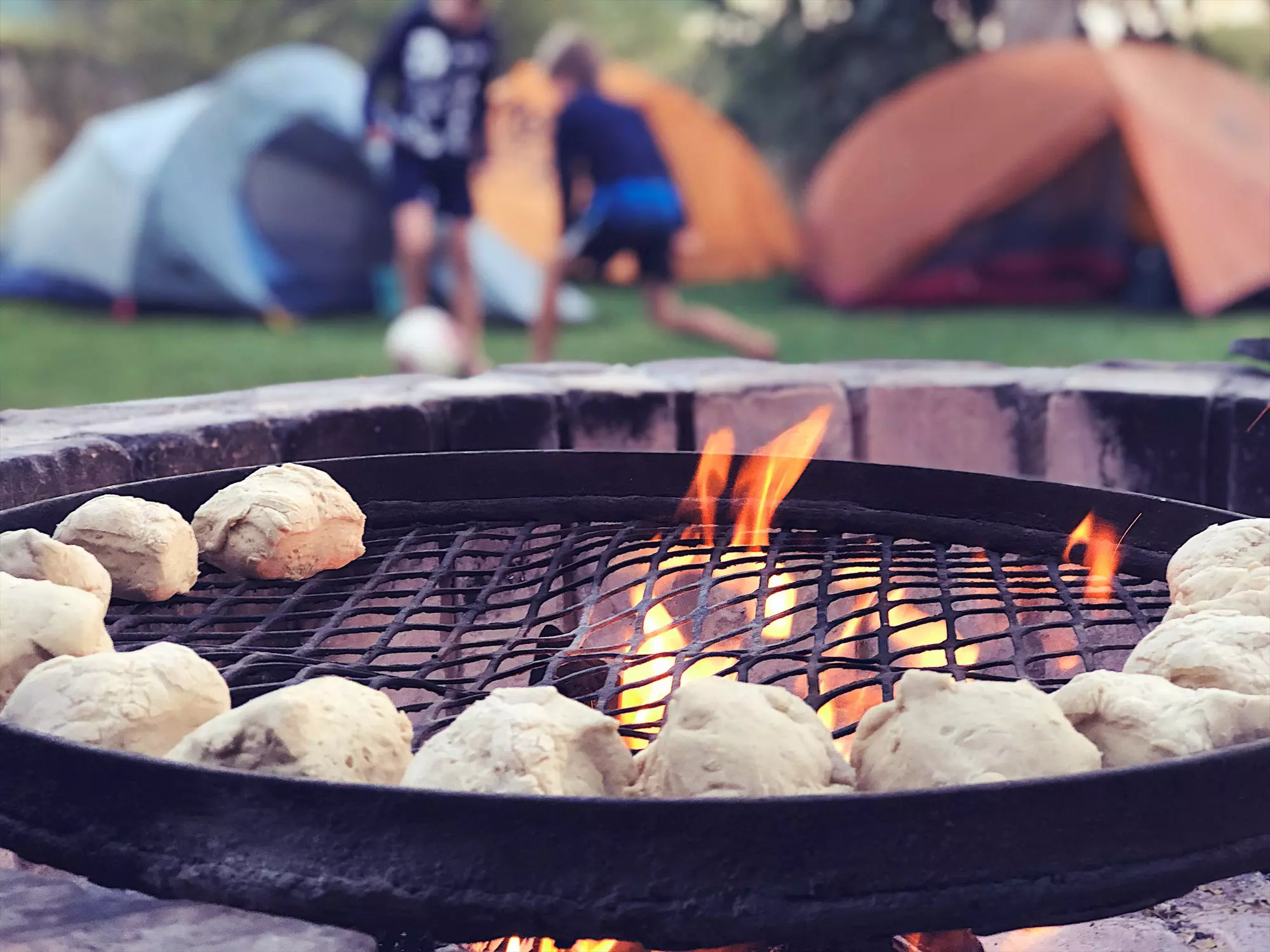 Use local braii (barbecue) facilities for a budget meal at a campsite © wilpunt / Getty Images